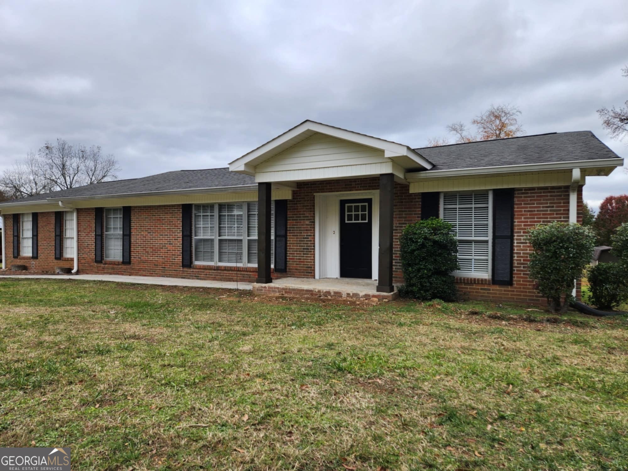 a front view of a house with garden