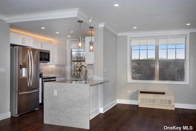 a kitchen with stainless steel appliances granite countertop a refrigerator and a stove top oven