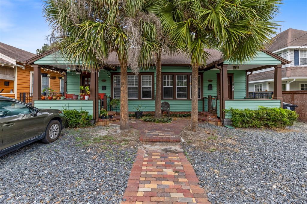 a front view of a house with a yard and entertaining space