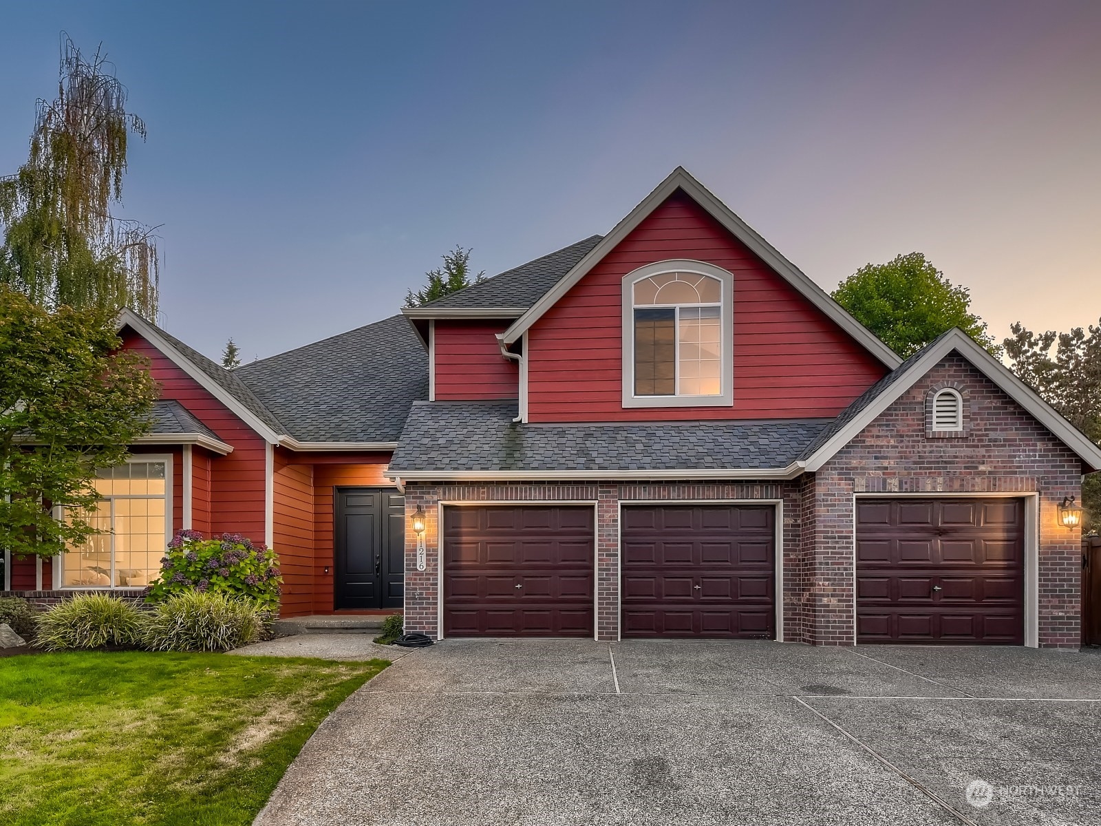 a front view of house with yard and garage