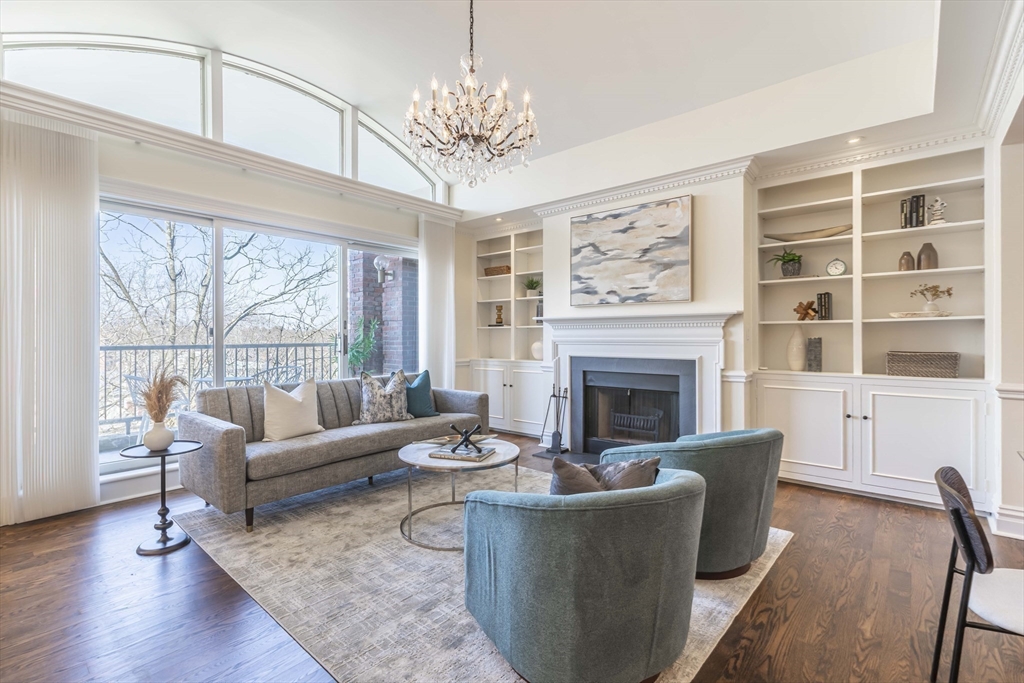 a living room with furniture a fireplace and a large window