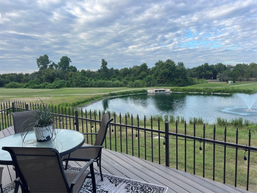 a view of a lake with a table and chairs