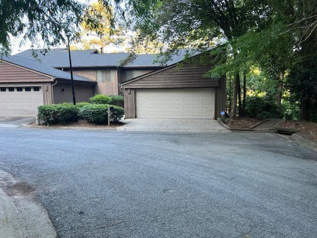 a view of a house with a tree and a yard