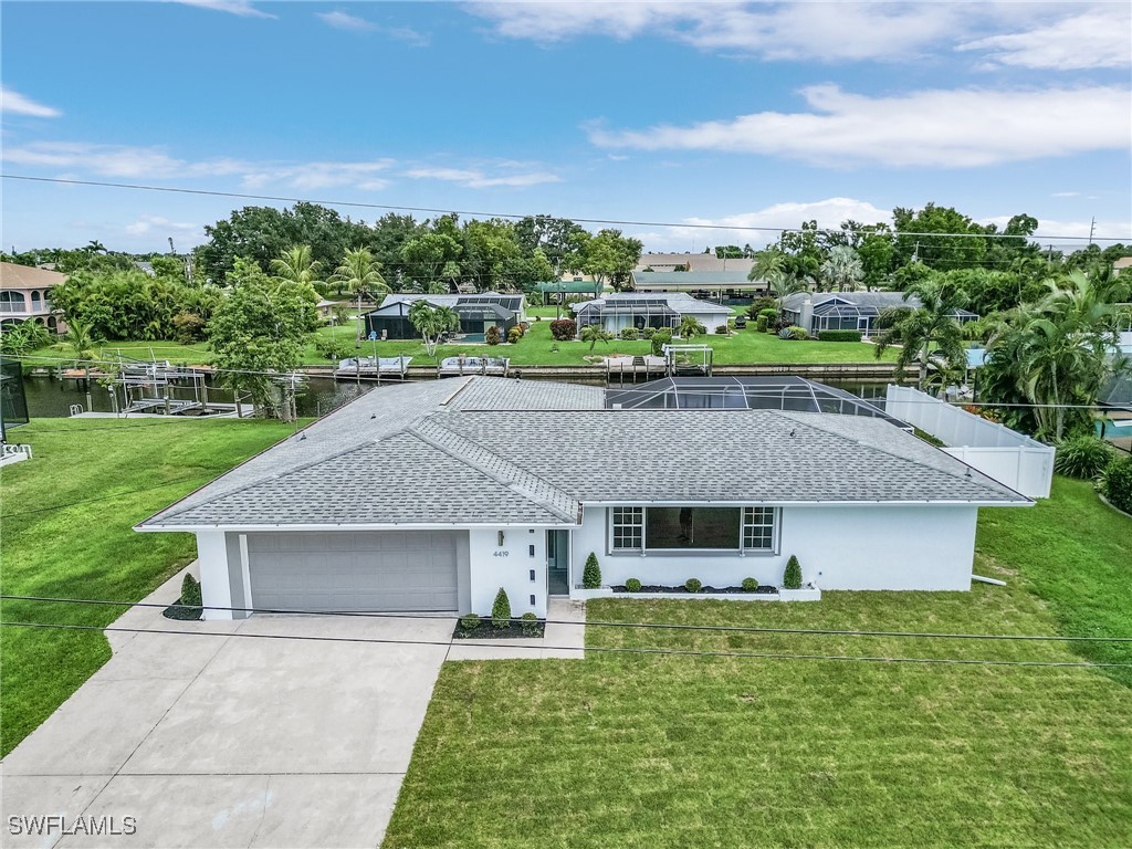 a aerial view of a house next to a big yard and large trees