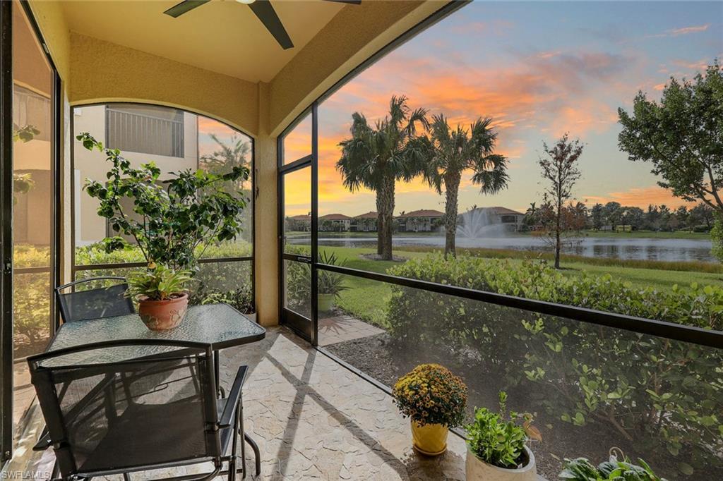 a balcony with furniture and a lake view