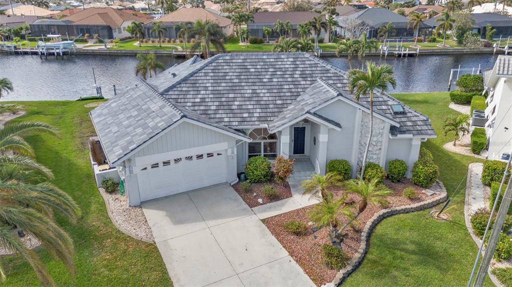 an aerial view of a house with a garden and plants