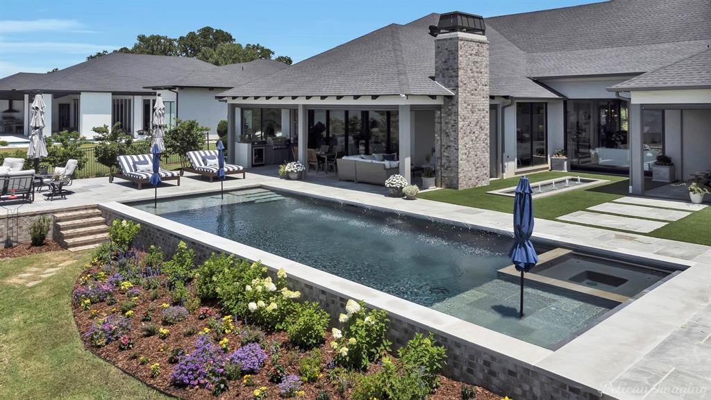 a view of a house with swimming pool and sitting area