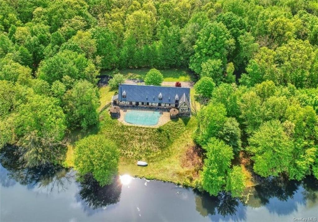 an aerial view of a house with a yard basket ball court and outdoor seating