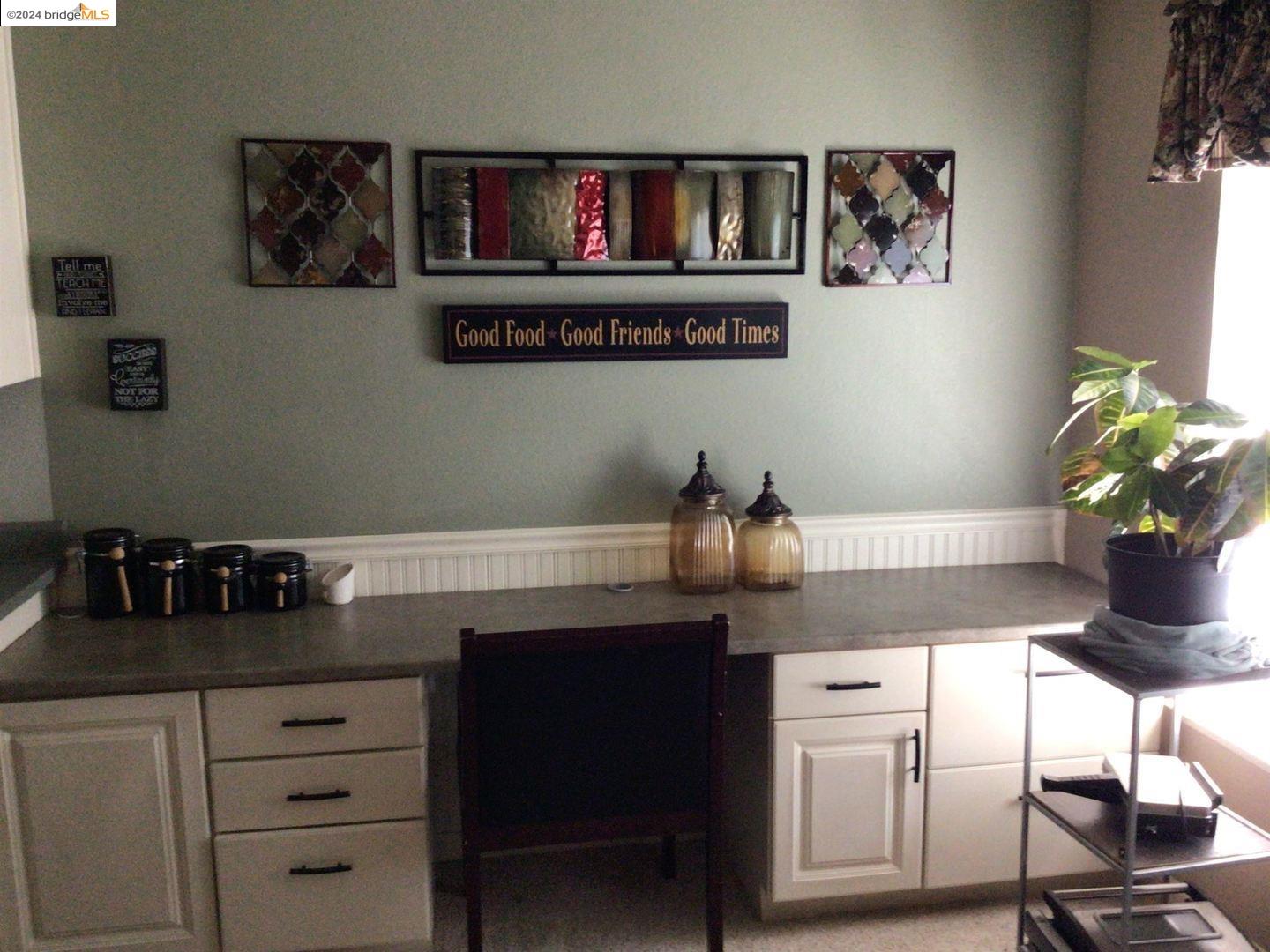 a kitchen with cabinets and window