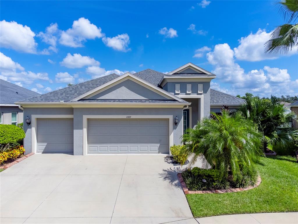 a front view of a house with a yard and garage