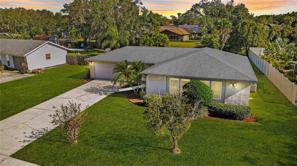 a aerial view of a house with a yard table and chairs