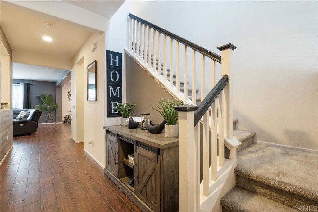 a view of entryway and hall with wooden floor