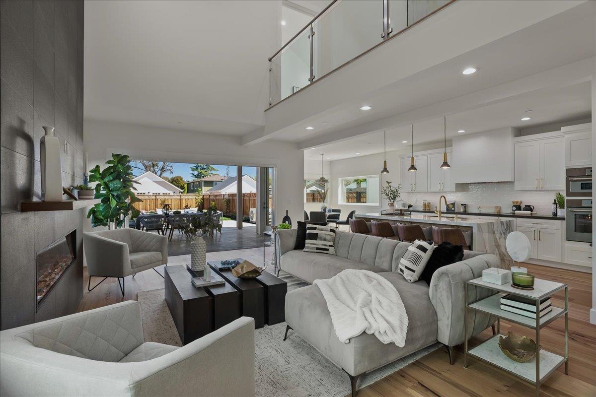 a living room with furniture and a dining table with kitchen view