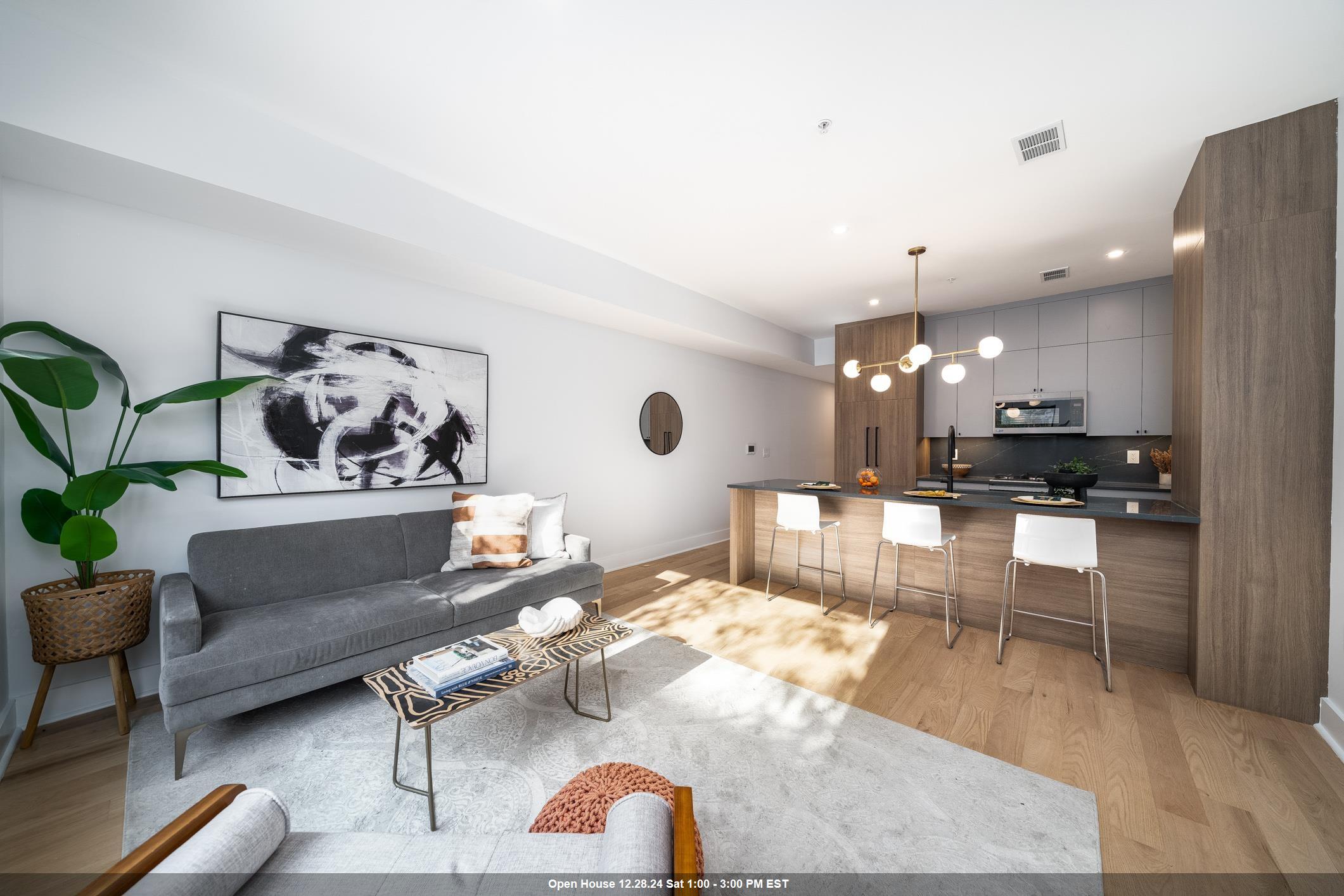 a living room with furniture and kitchen view