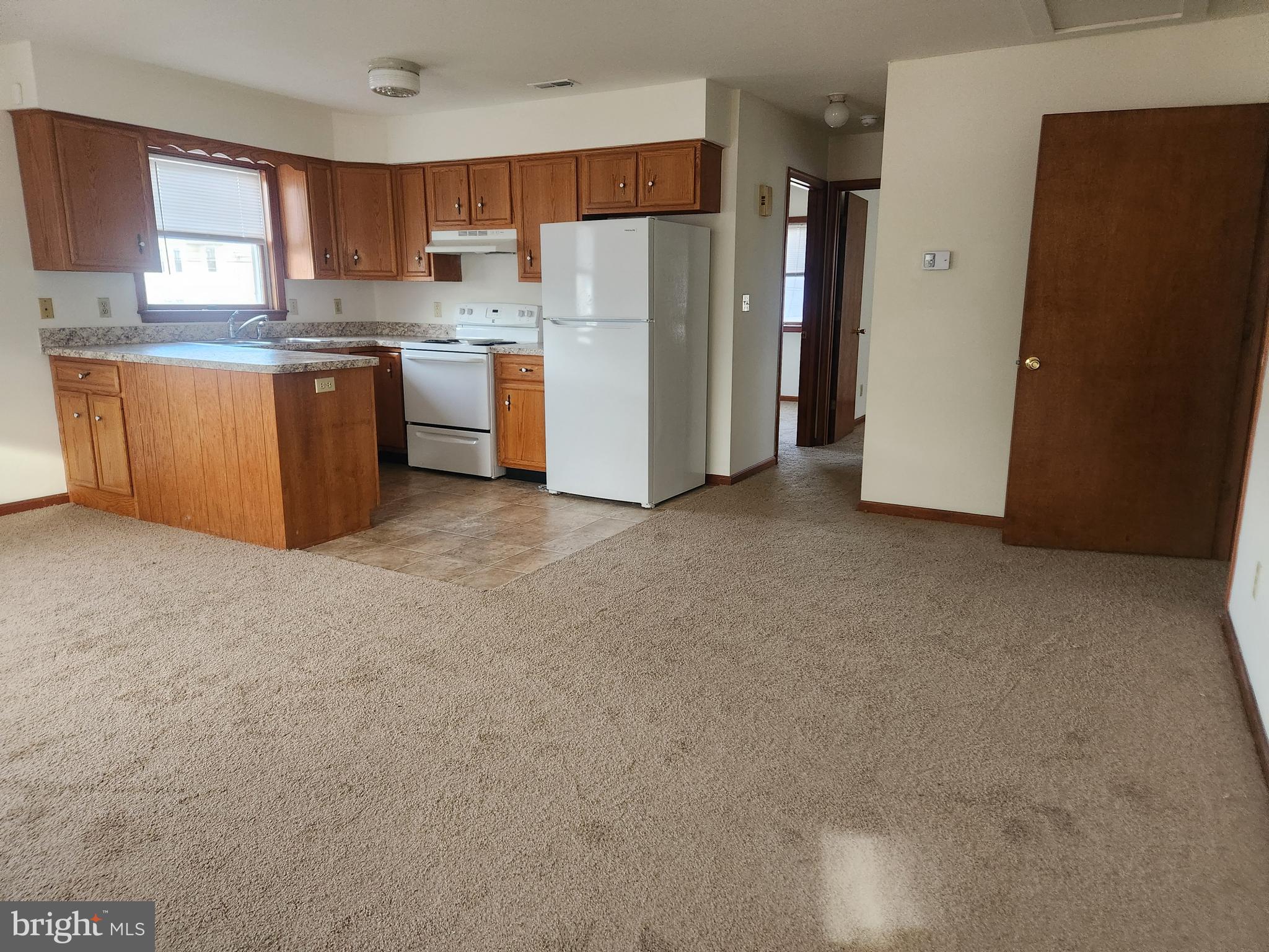 a kitchen with stainless steel appliances a refrigerator and a stove top oven