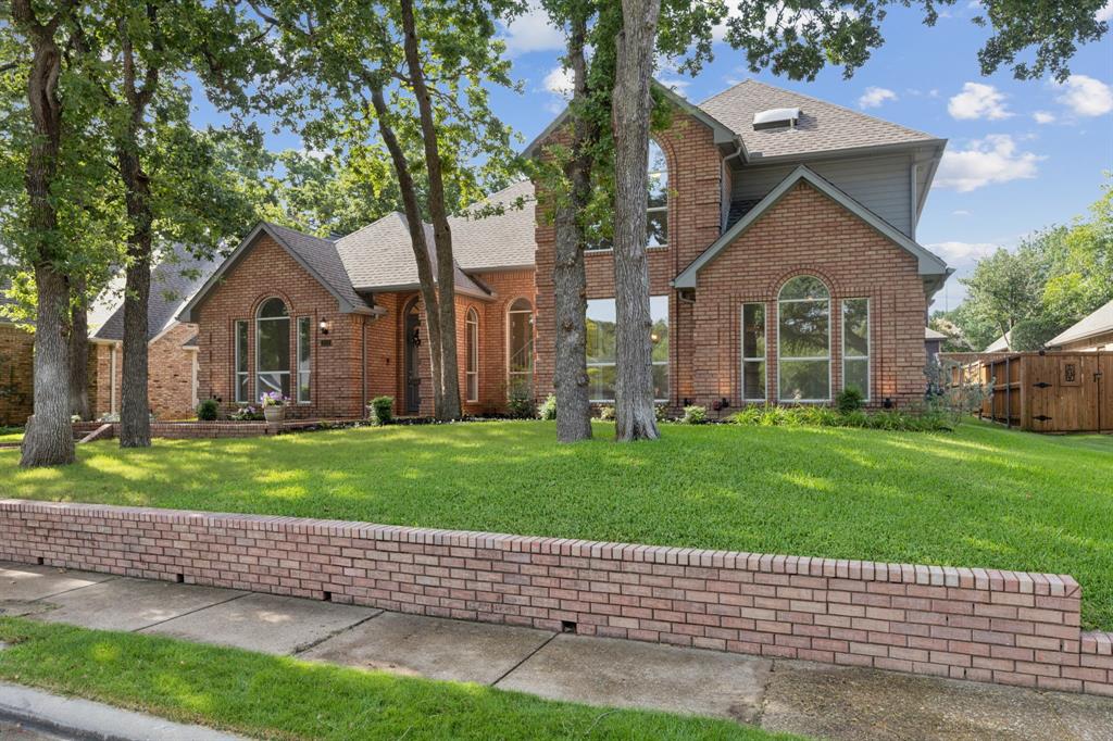 a front view of a house with a yard and a garage