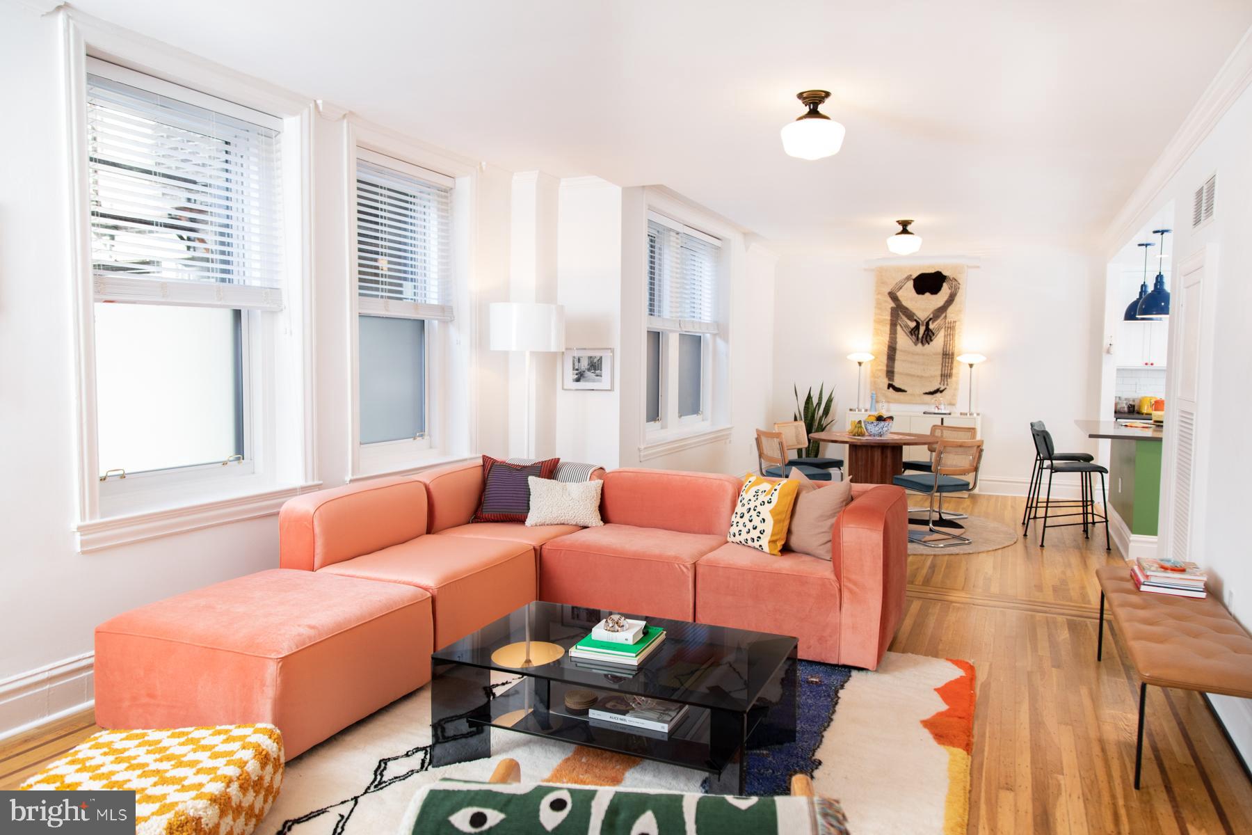 a living room with furniture and wooden floor