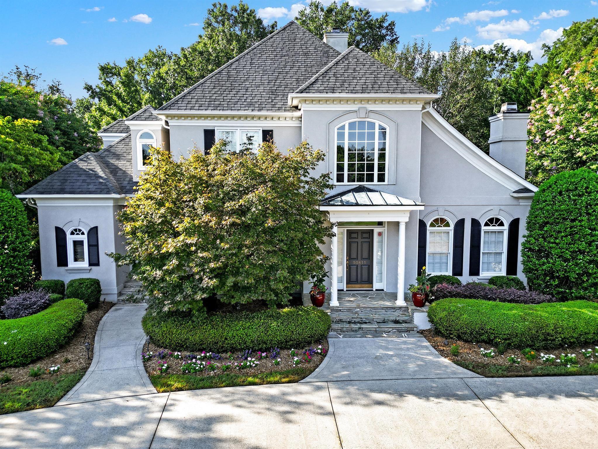 a front view of a house with a garden