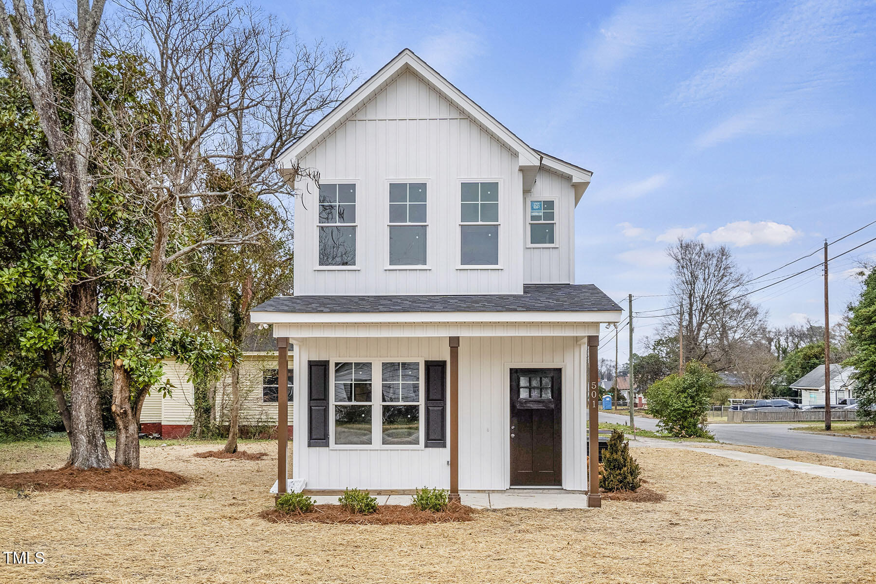 a view of a house with a yard and tree s