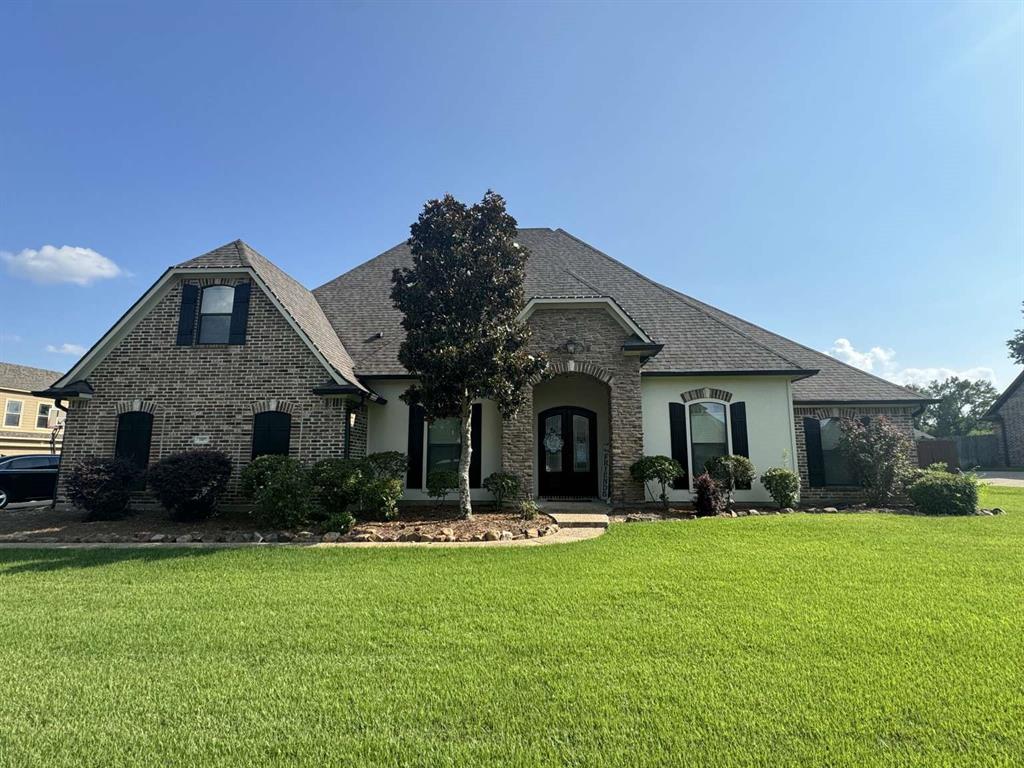 a front view of house with yard and green space