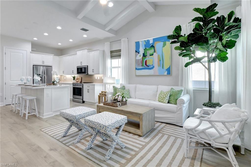 a living room with furniture potted plant and window