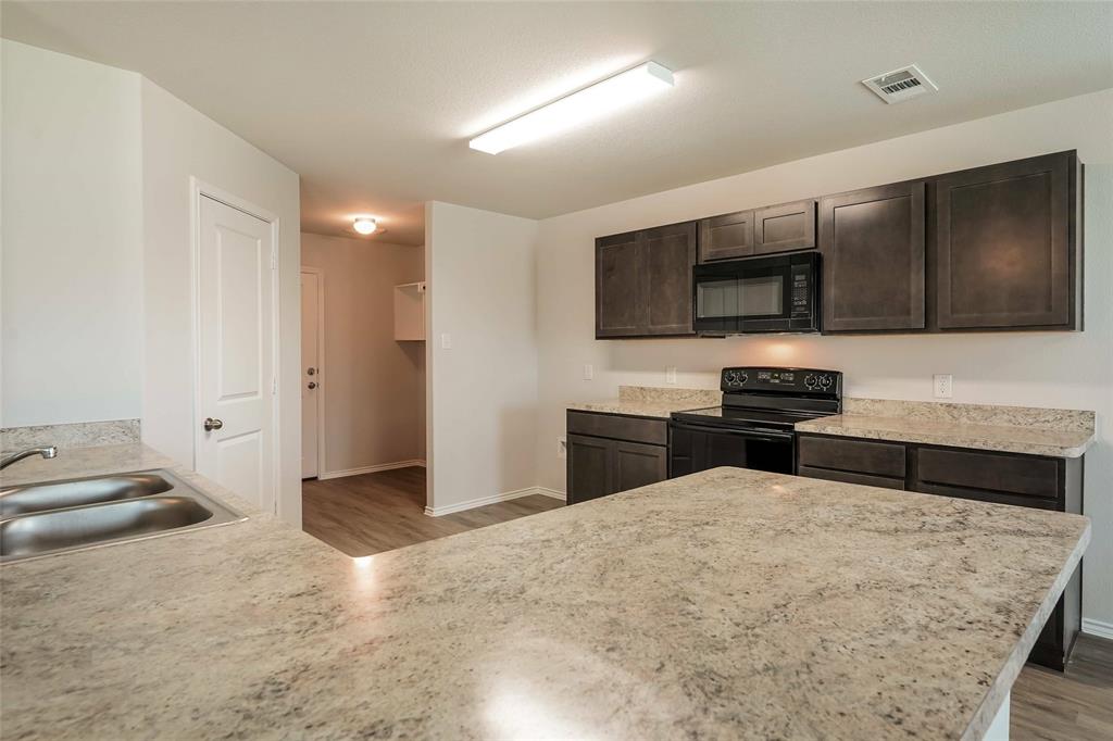 a kitchen with a sink and a stove top oven