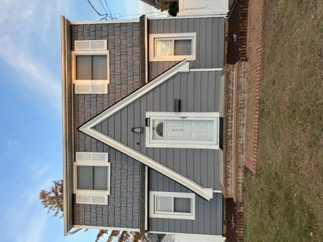 a view of a house with wooden fence