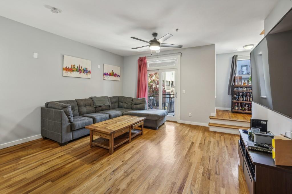 a living room with furniture and a wooden floor