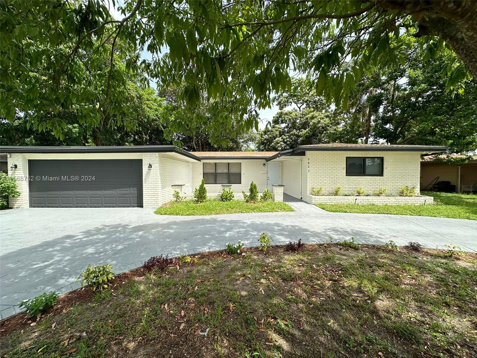 a front view of house with yard and trees