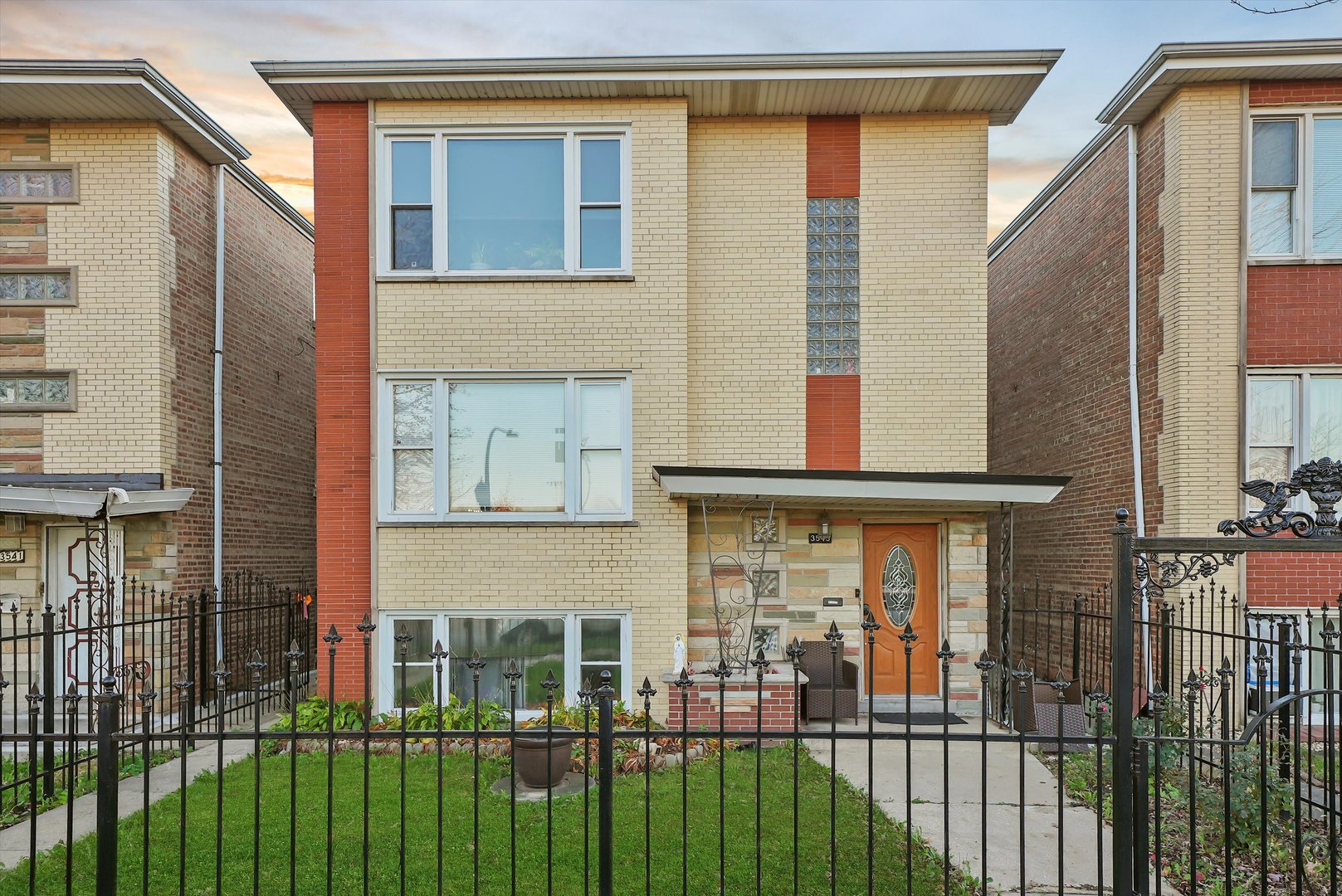 a view of a brick house with many windows