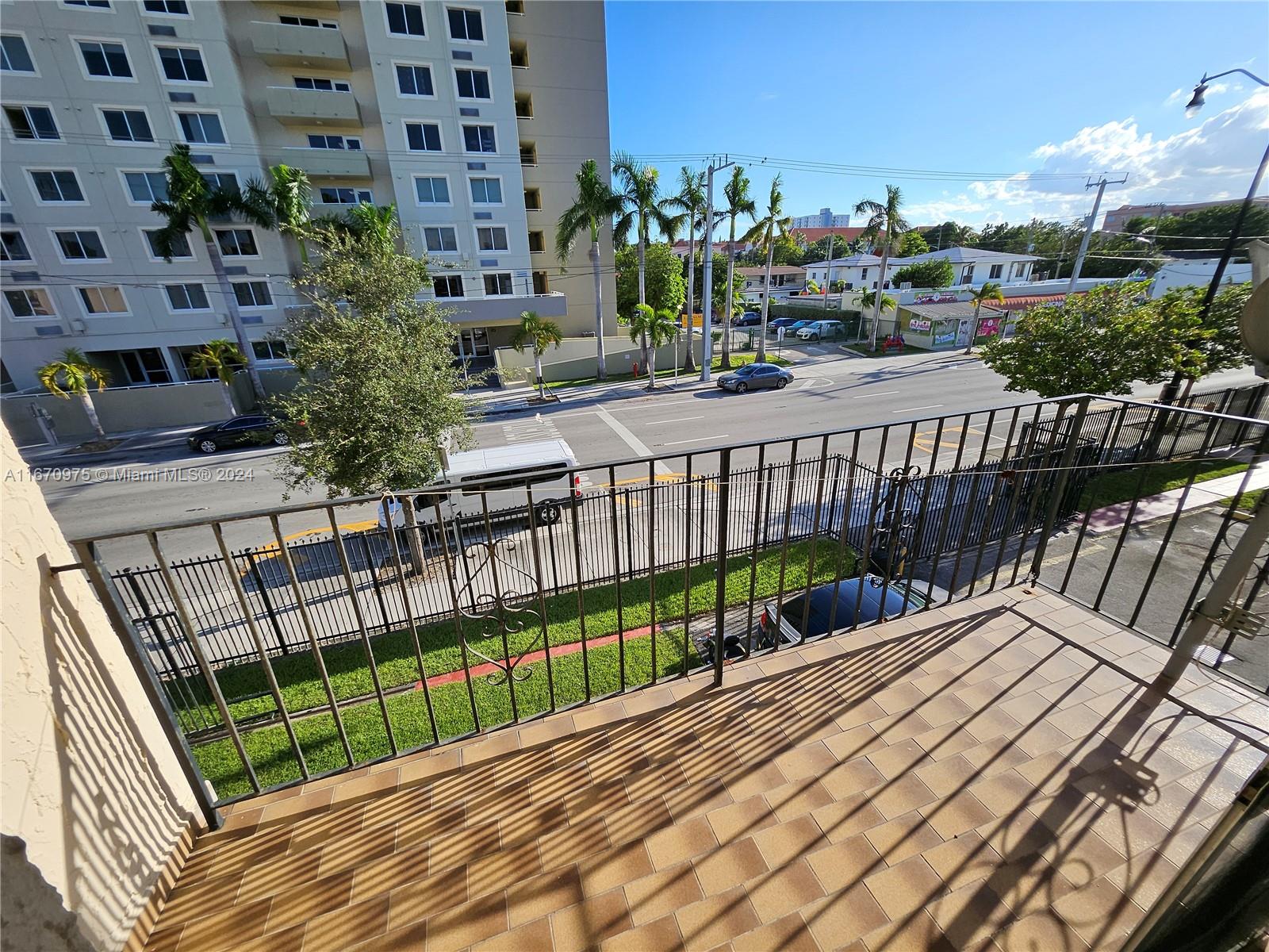 a view of a balcony with wooden fence