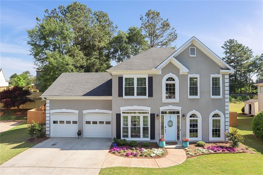 a front view of house with yard and green space