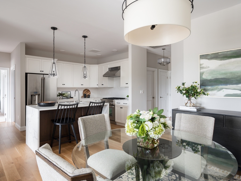 a dining room with furniture a chandelier and window