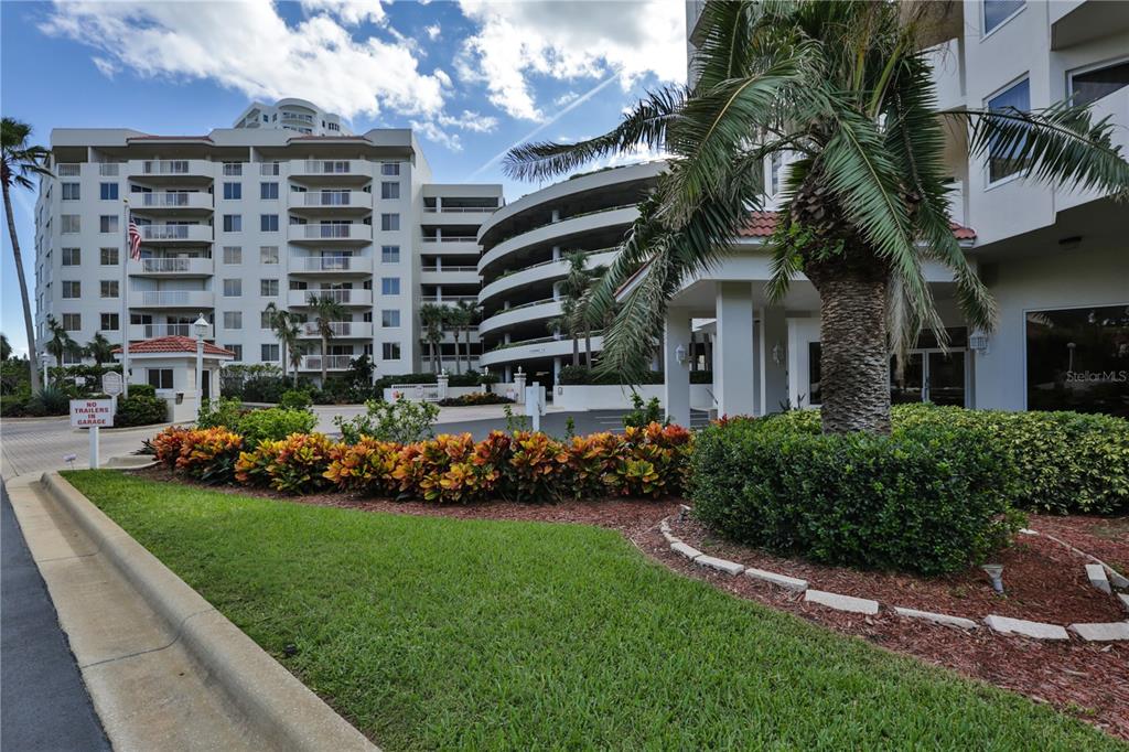 a front view of a multi story building with yard