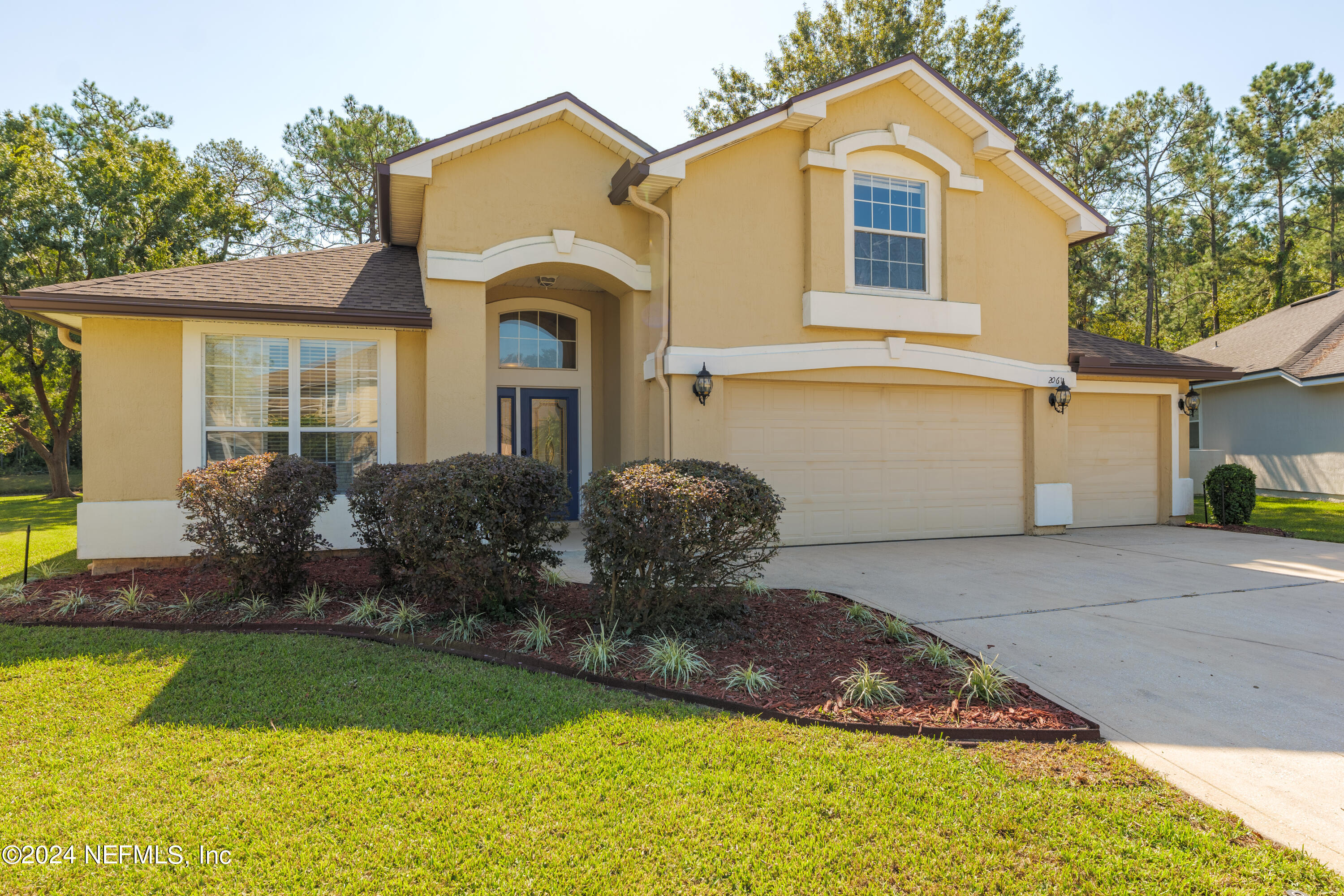 a front view of a house with a yard and garage