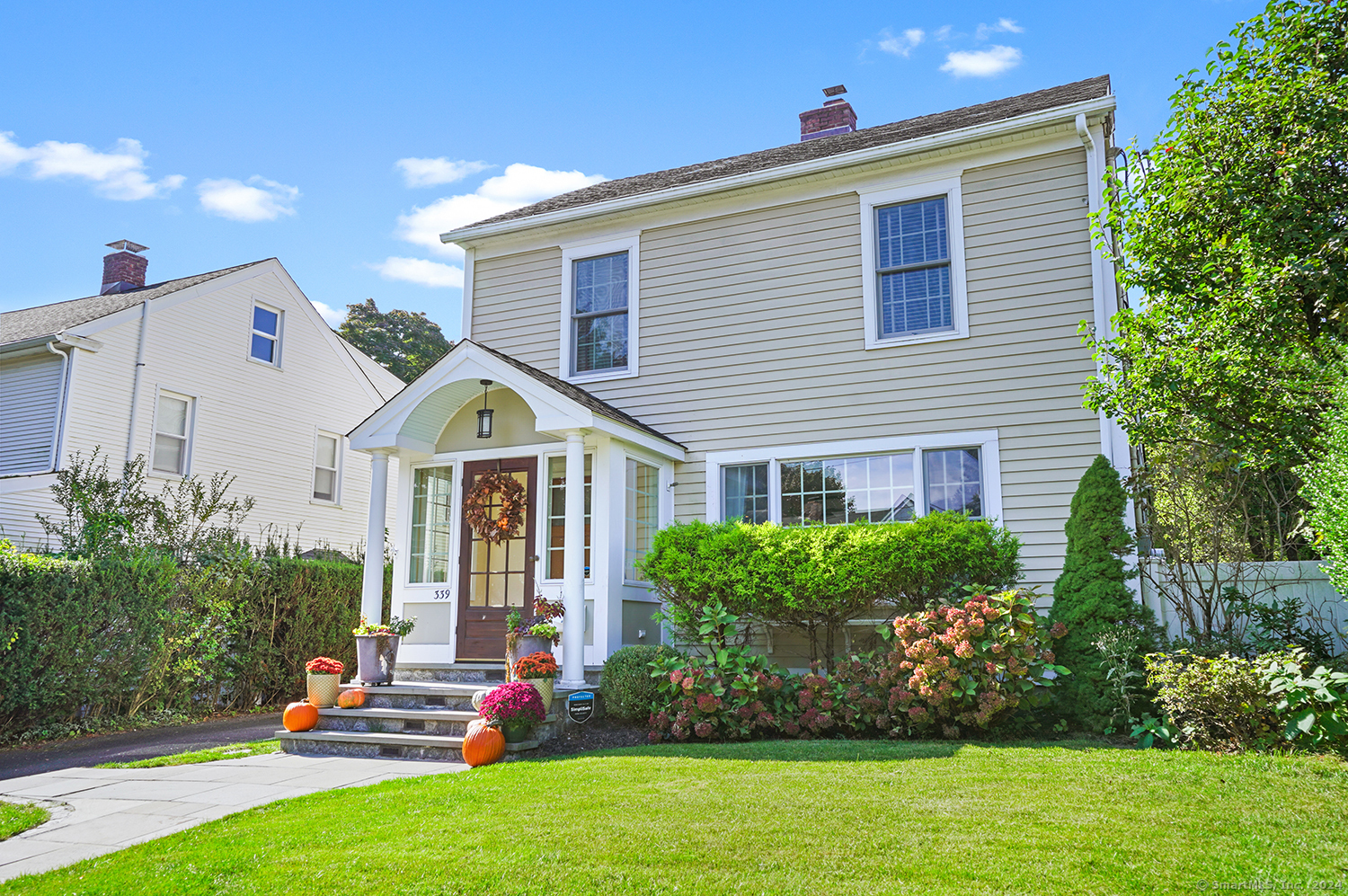 a view of a house with a small yard and plants