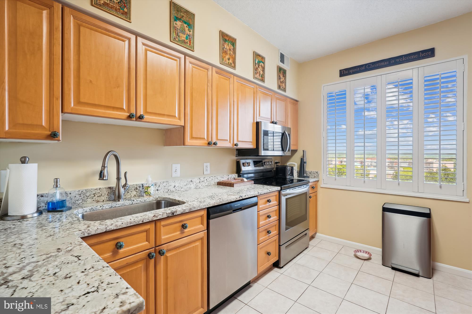 a kitchen with stainless steel appliances granite countertop a sink and cabinets