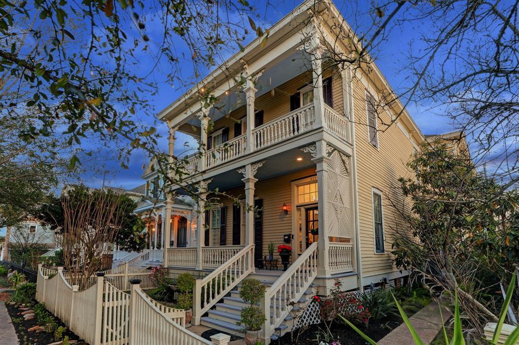 a front view of a house with a tree