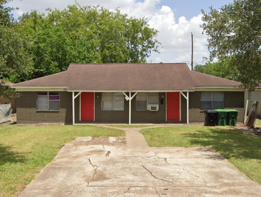 a house that has a tree in front of it