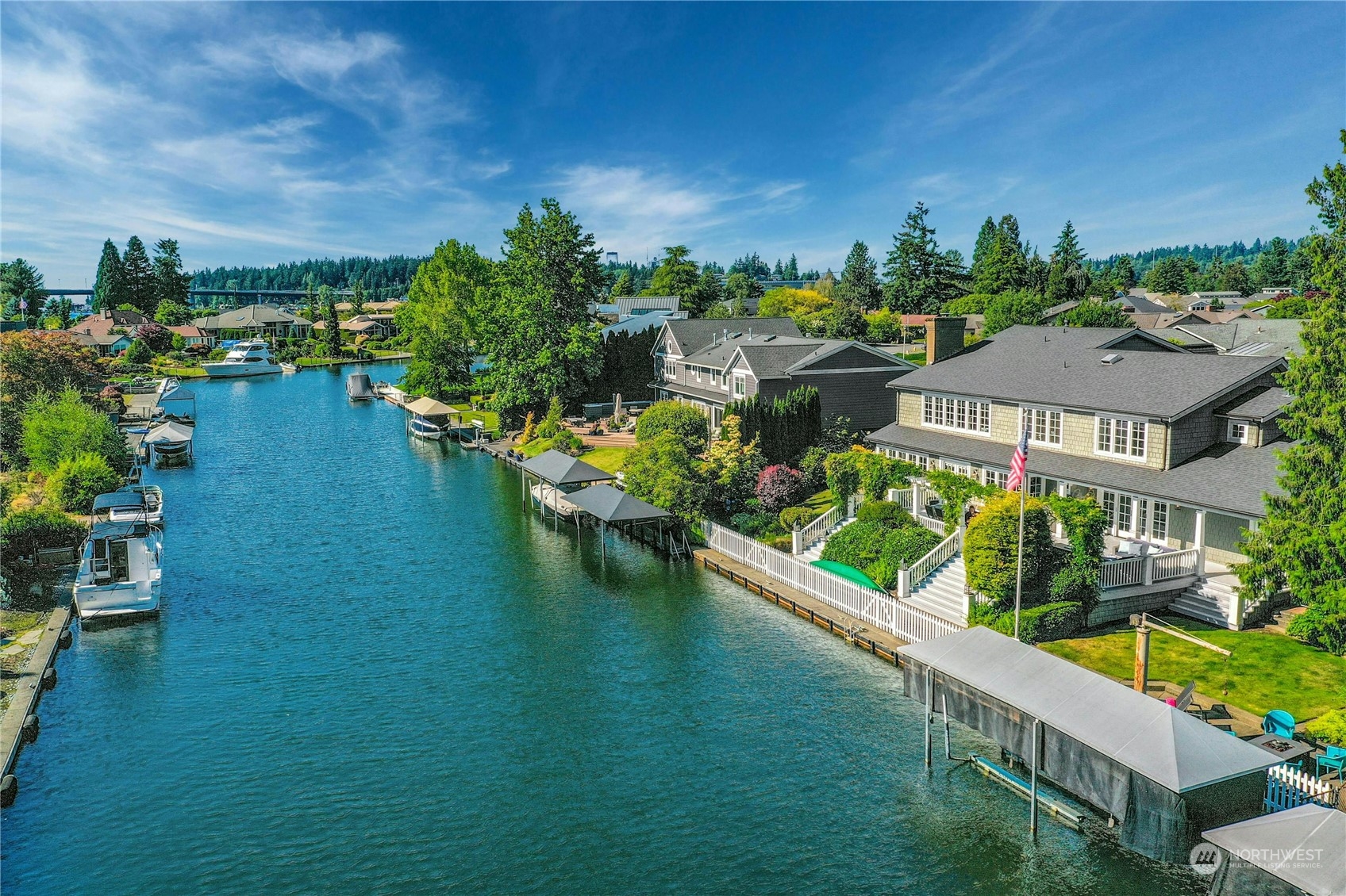 an aerial view of residential houses with outdoor space and swimming pool