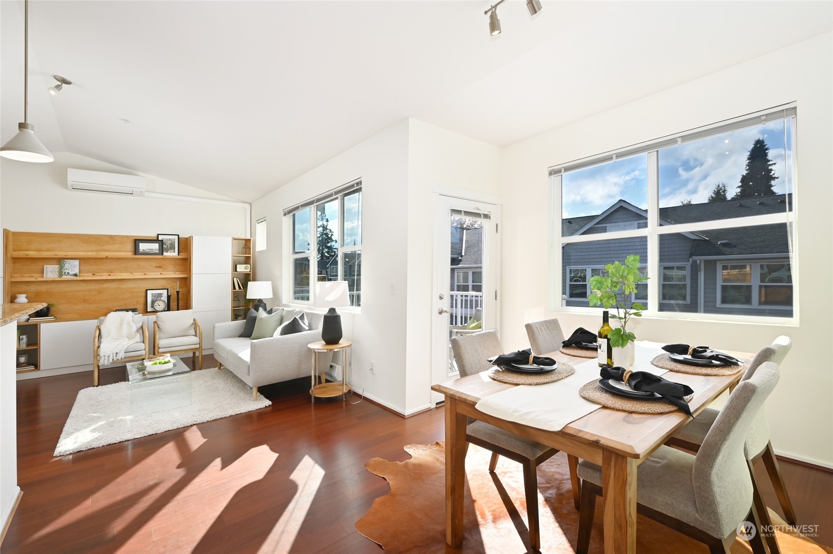 a living room with furniture and large windows