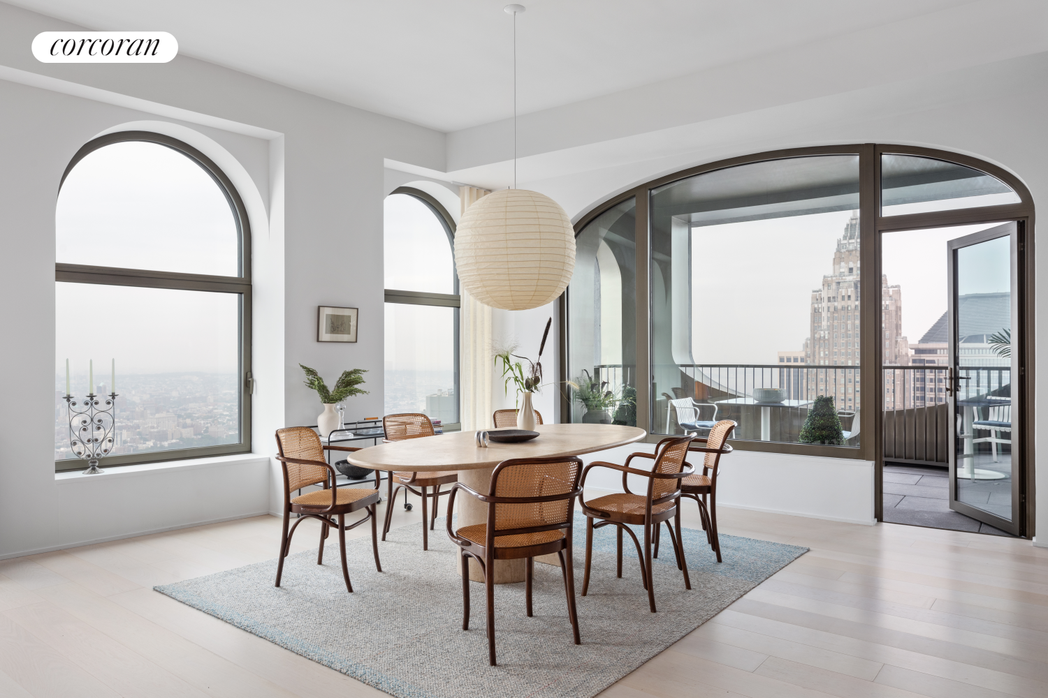 a dining room with furniture a chandelier and a rug