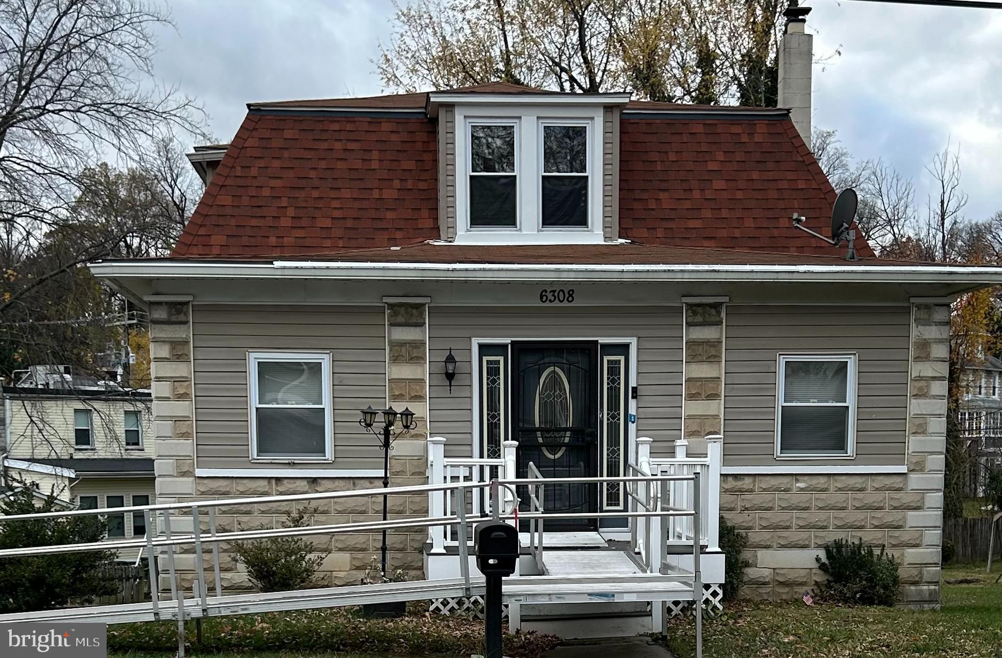 a view of a house with entrance door and two windows