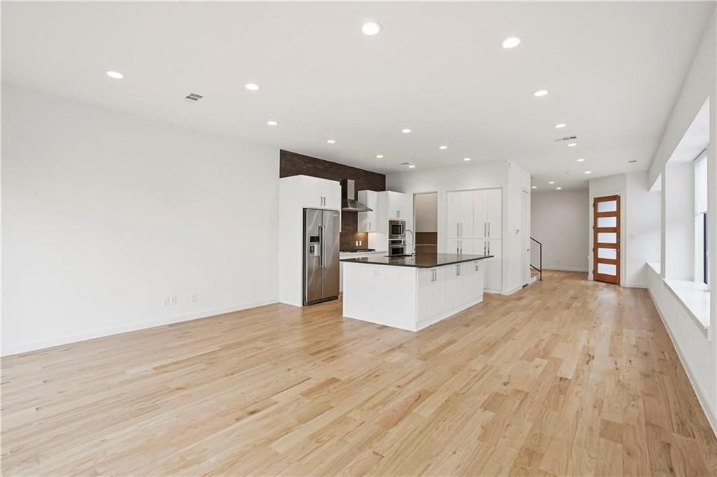 a view of kitchen with refrigerator and microwave