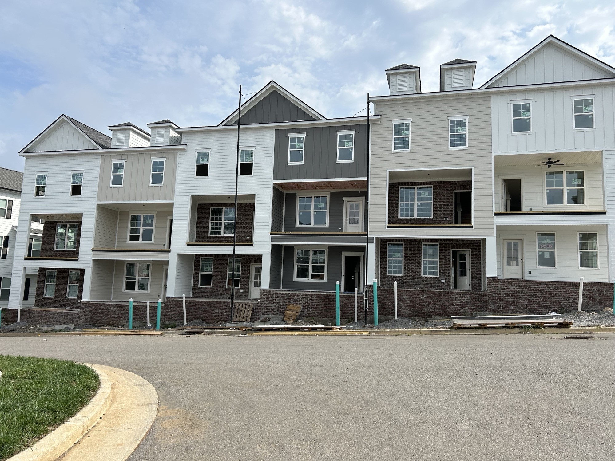 a front view of a residential apartment building with a yard