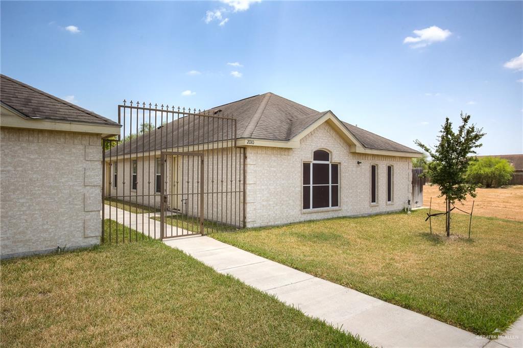 a view of a house with a backyard and a patio