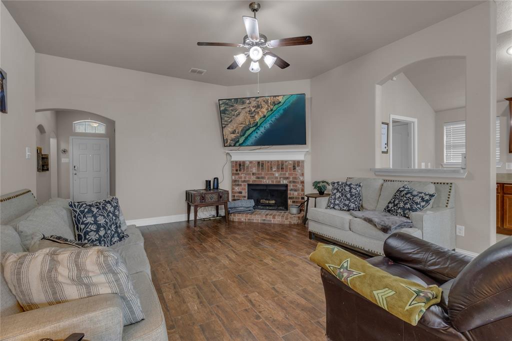 a living room with furniture a fireplace and a chandelier