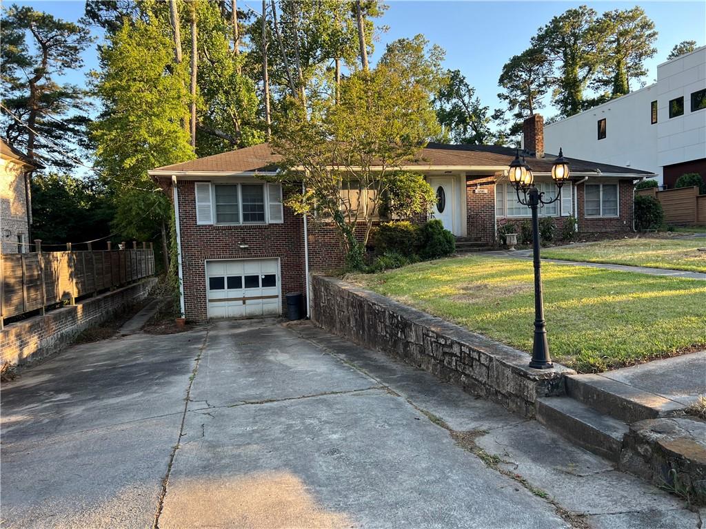 a view of a house with a yard and a patio