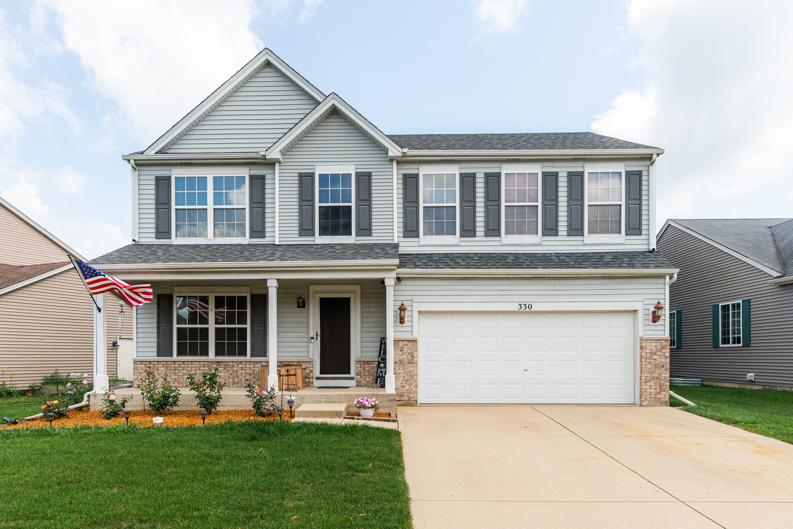 a front view of house with yard and green space