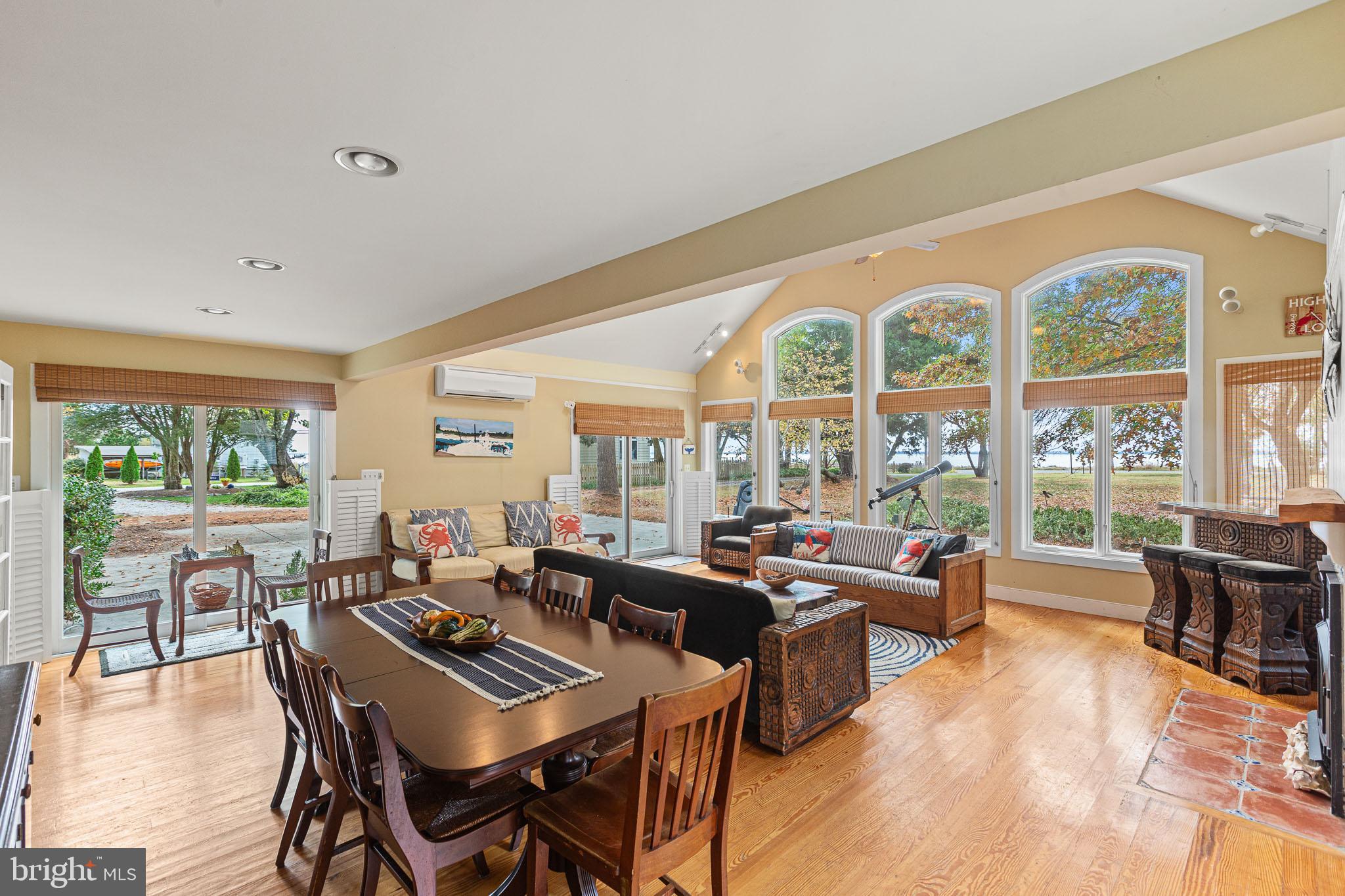 a living room with furniture and floor to ceiling windows